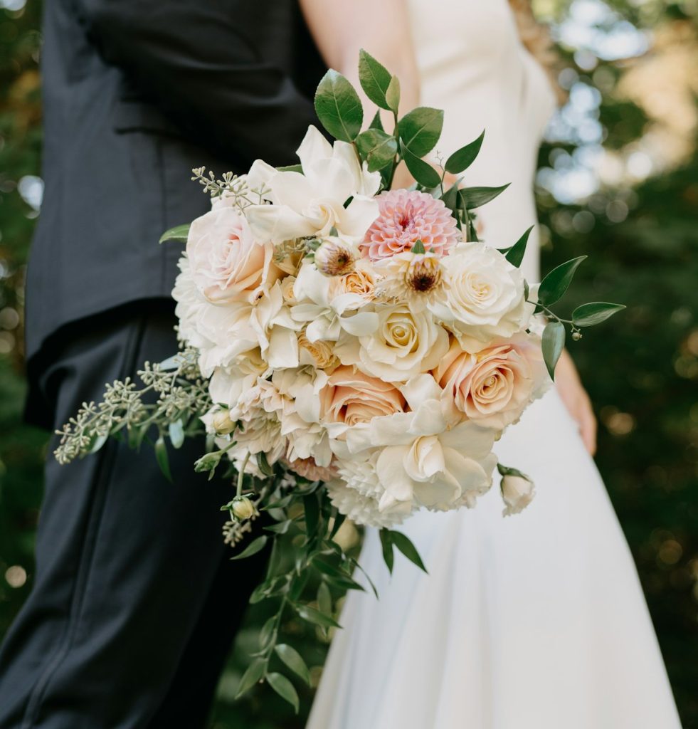 Bride and groom holding a bouquet of flowers