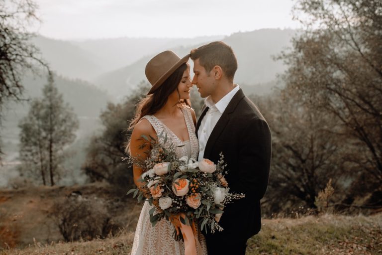 Groom holding a bouquet of flowers